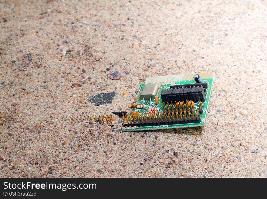 Out-of-date sound card in sand close up. Out-of-date sound card in sand close up