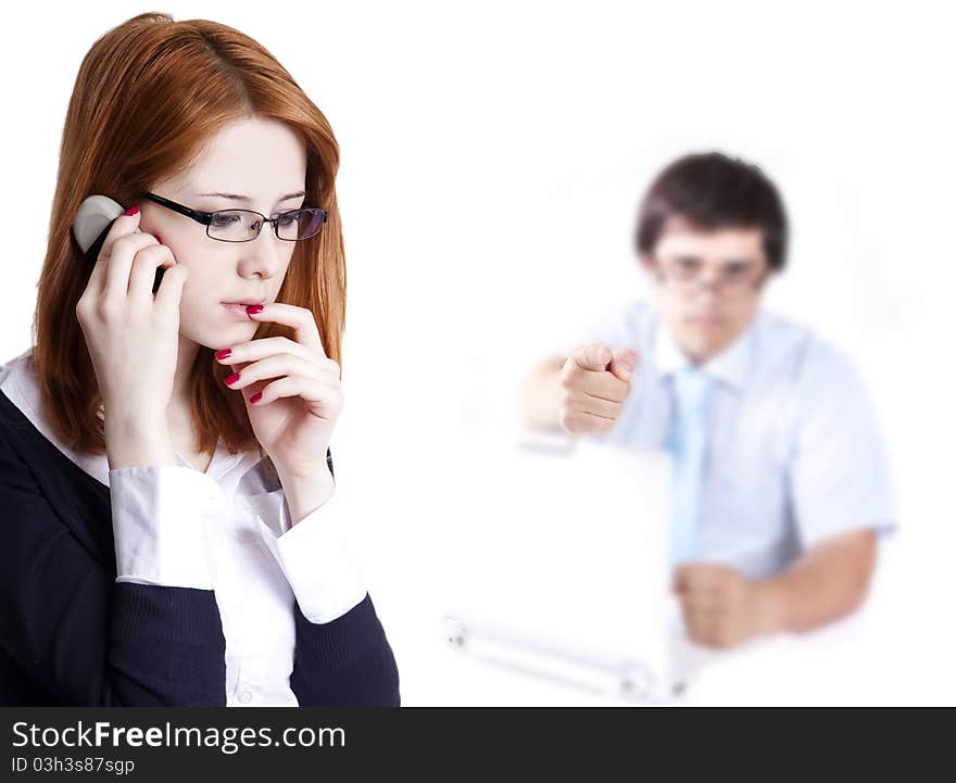 Sad business women calling by phone and boss at background point at her. Sad business women calling by phone and boss at background point at her.