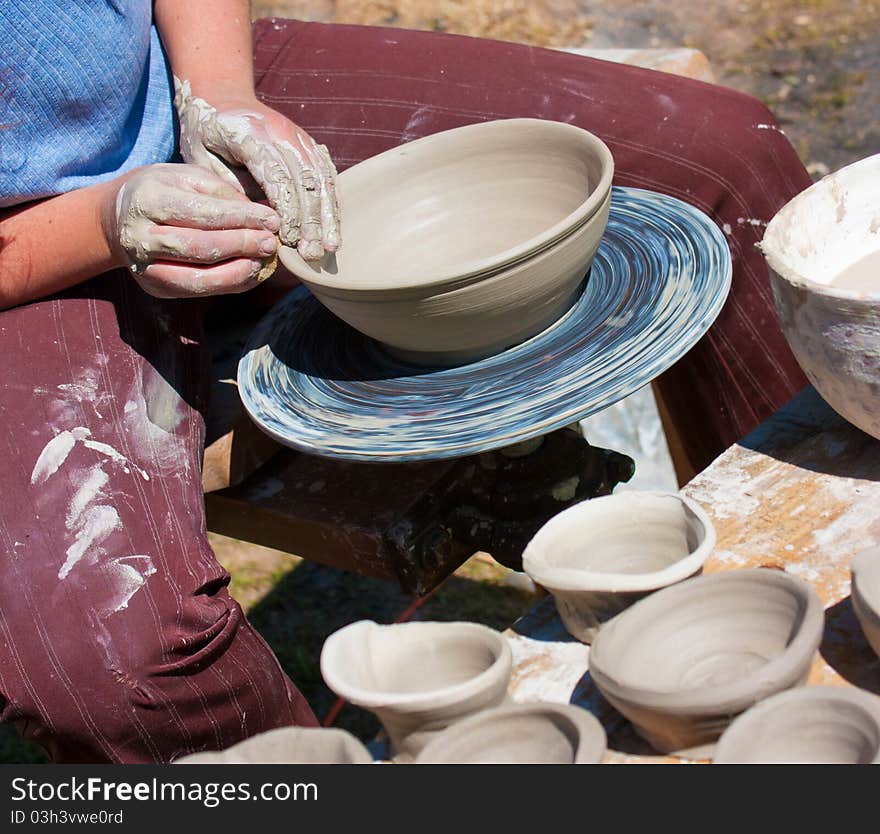 Potter hands working on pottery wheel