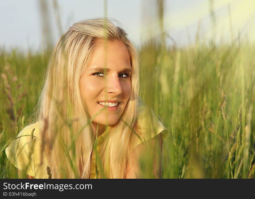 Beautiful blond girl in grass with sunshine. Beautiful blond girl in grass with sunshine