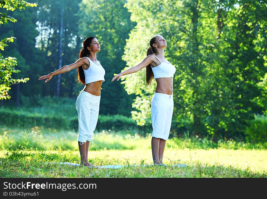 Yoga woman on green park background