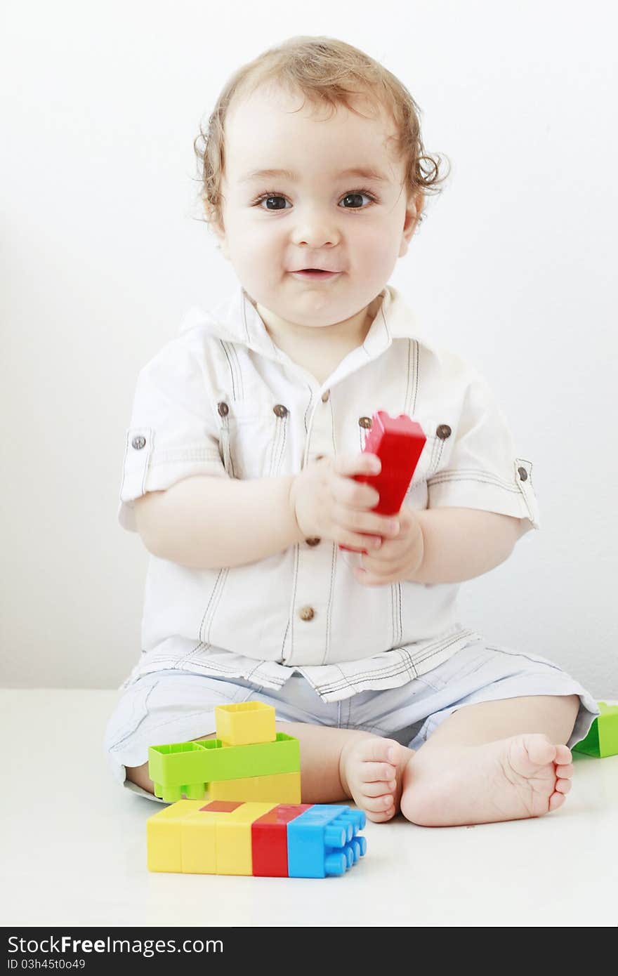 Infant playing with lego