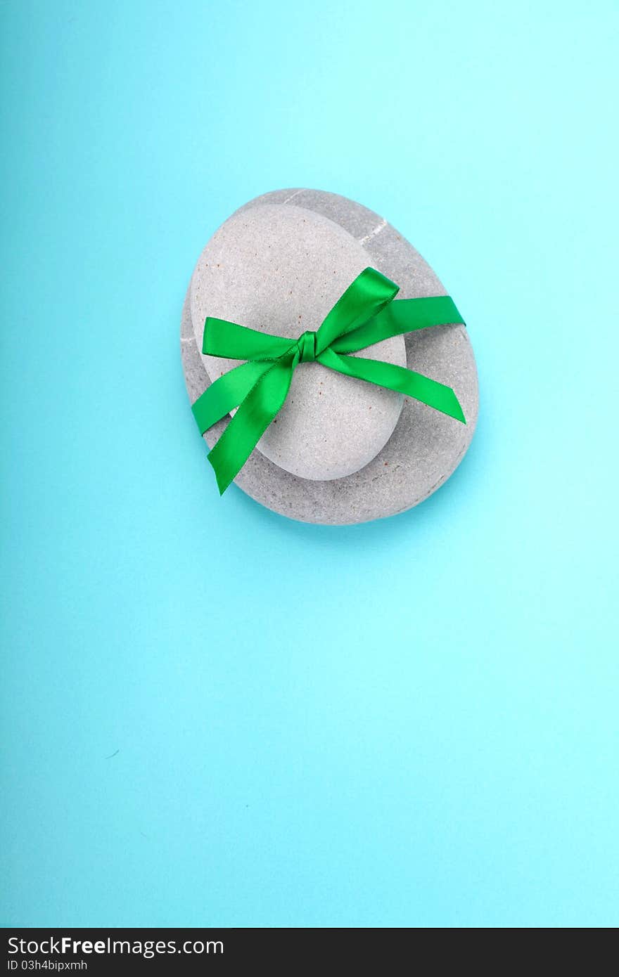 Stack of rocks wrapped in green ribbon