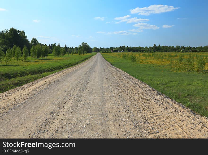 Dirty rural road in countryside, going over the meadow. Dirty rural road in countryside, going over the meadow