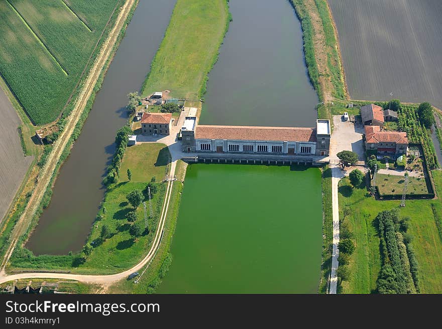 Barrier dam on the river with green water and scooping campaign