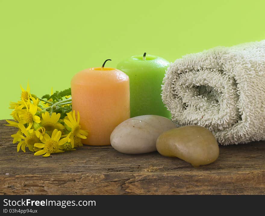 With candles and fresh yellow flowers on the wood. With candles and fresh yellow flowers on the wood