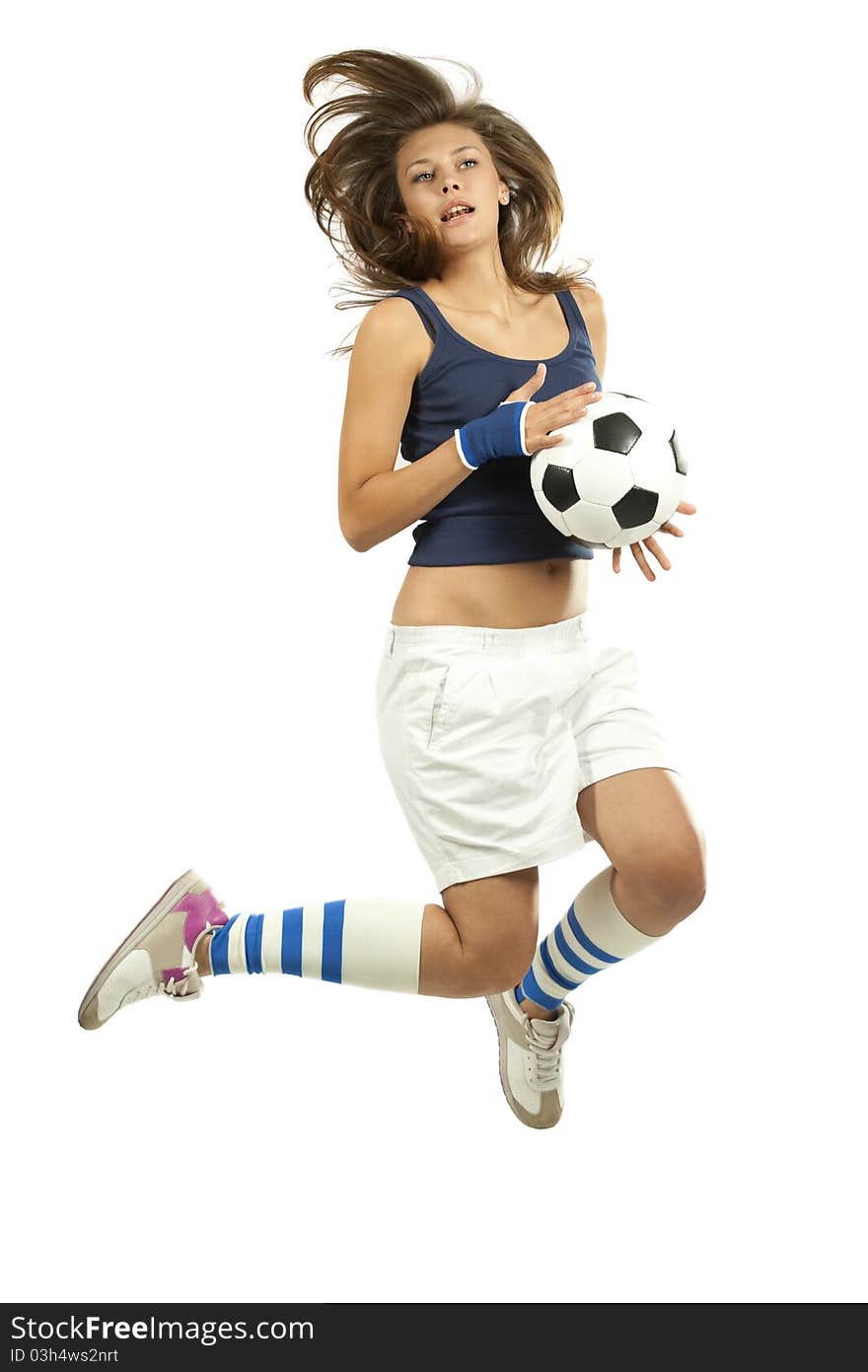 Girl jumpig with soccer ball in mid air with over white background