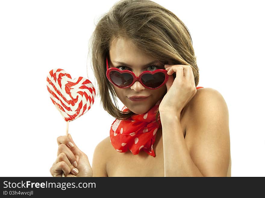 Close-up portrait of young woman with heart shaped lollipop and sunglasses. Close-up portrait of young woman with heart shaped lollipop and sunglasses