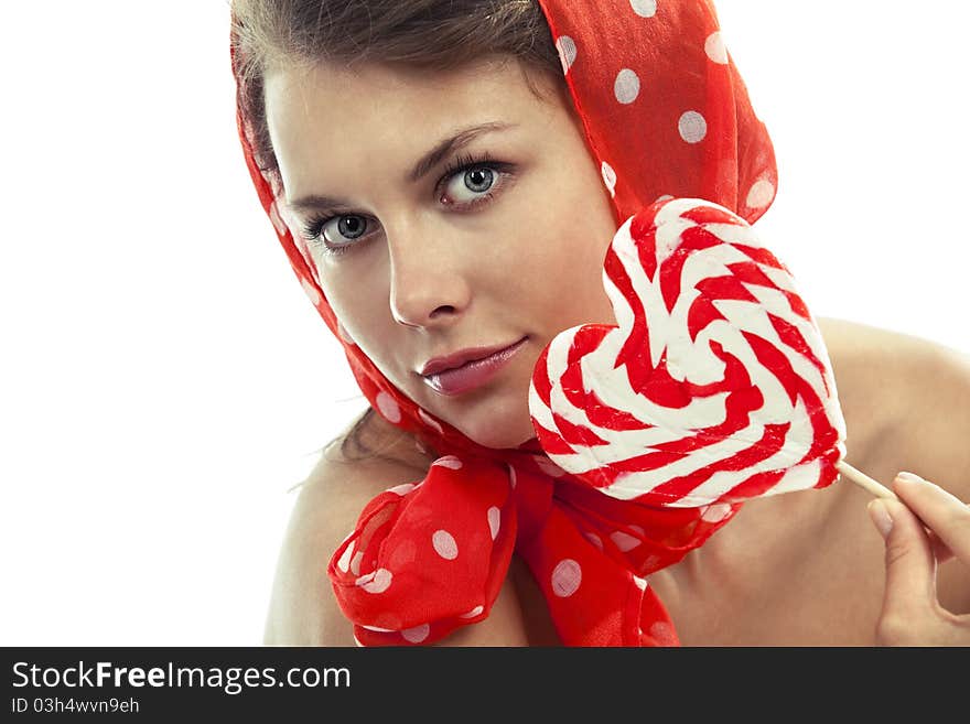 Close-up portrait of young woman with heart shaped lollipop