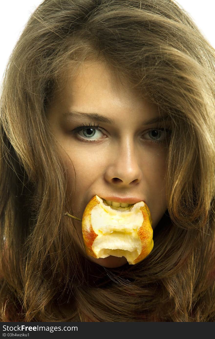 Young beautiful woman with bit of an apple in her mouth