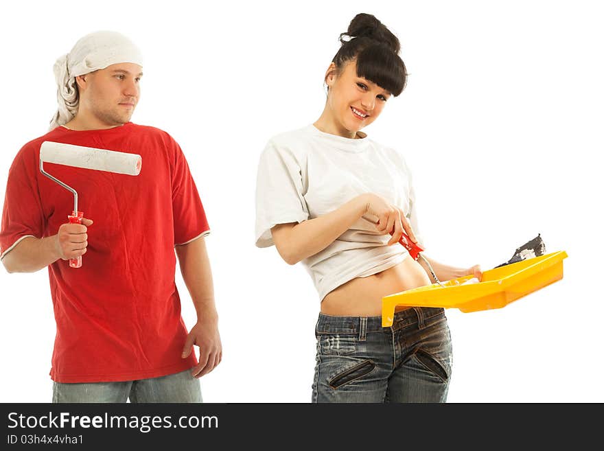 Cheerful young couple of workers preparing to painting a wall