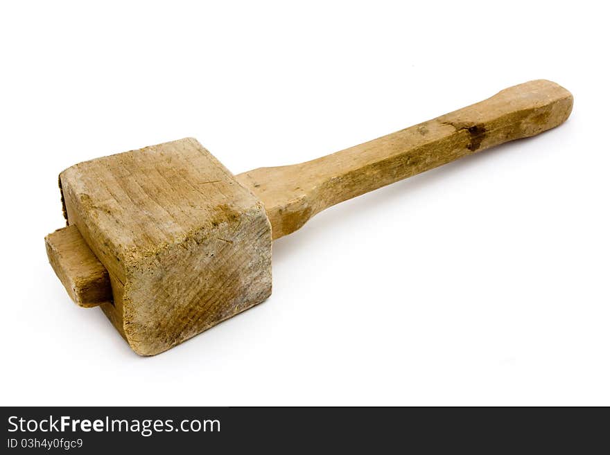 Old wooden mallet over white