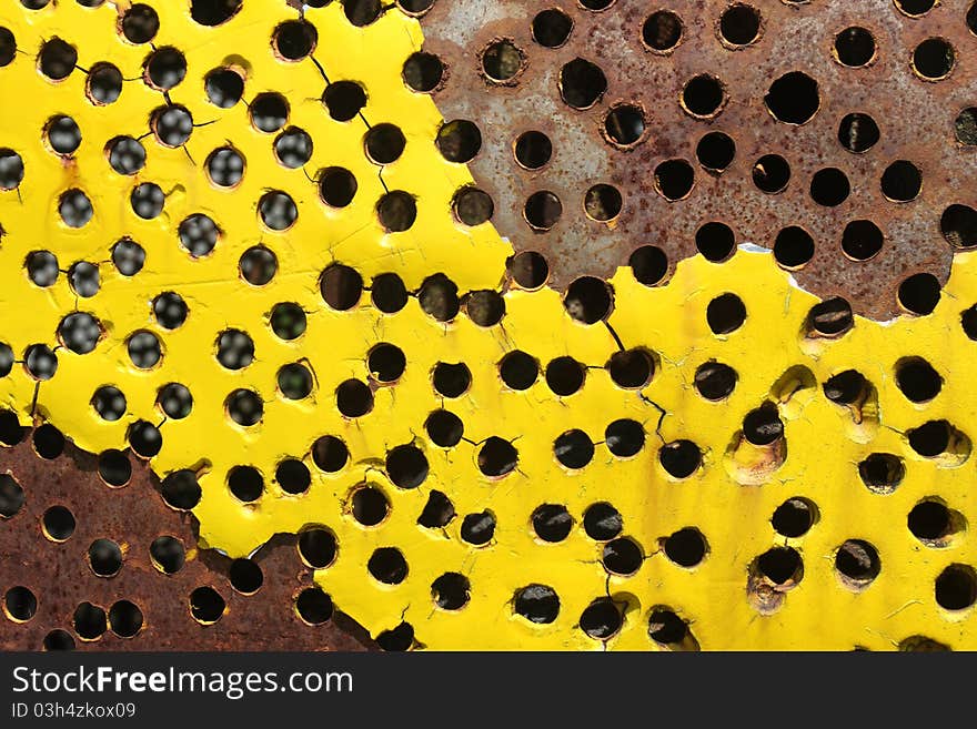 Hole and rust on yellow metal plate. Hole and rust on yellow metal plate.