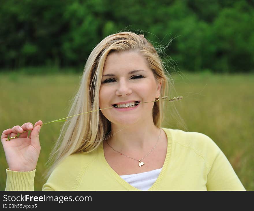 Beautiful natural woman with pure healthy skin outdoors on spring field. Switzerland. Beautiful natural woman with pure healthy skin outdoors on spring field. Switzerland