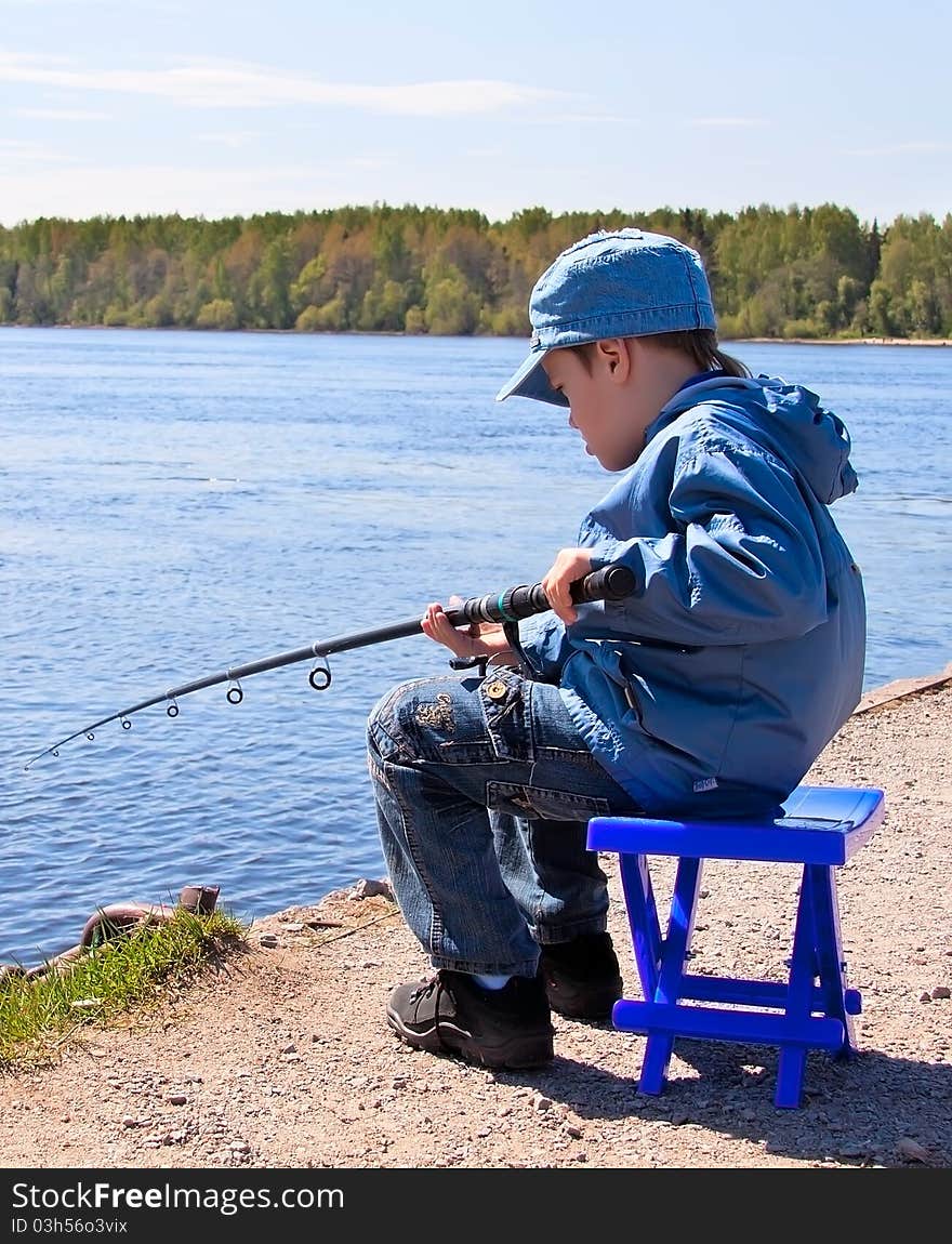 Boy is catching fish on the river