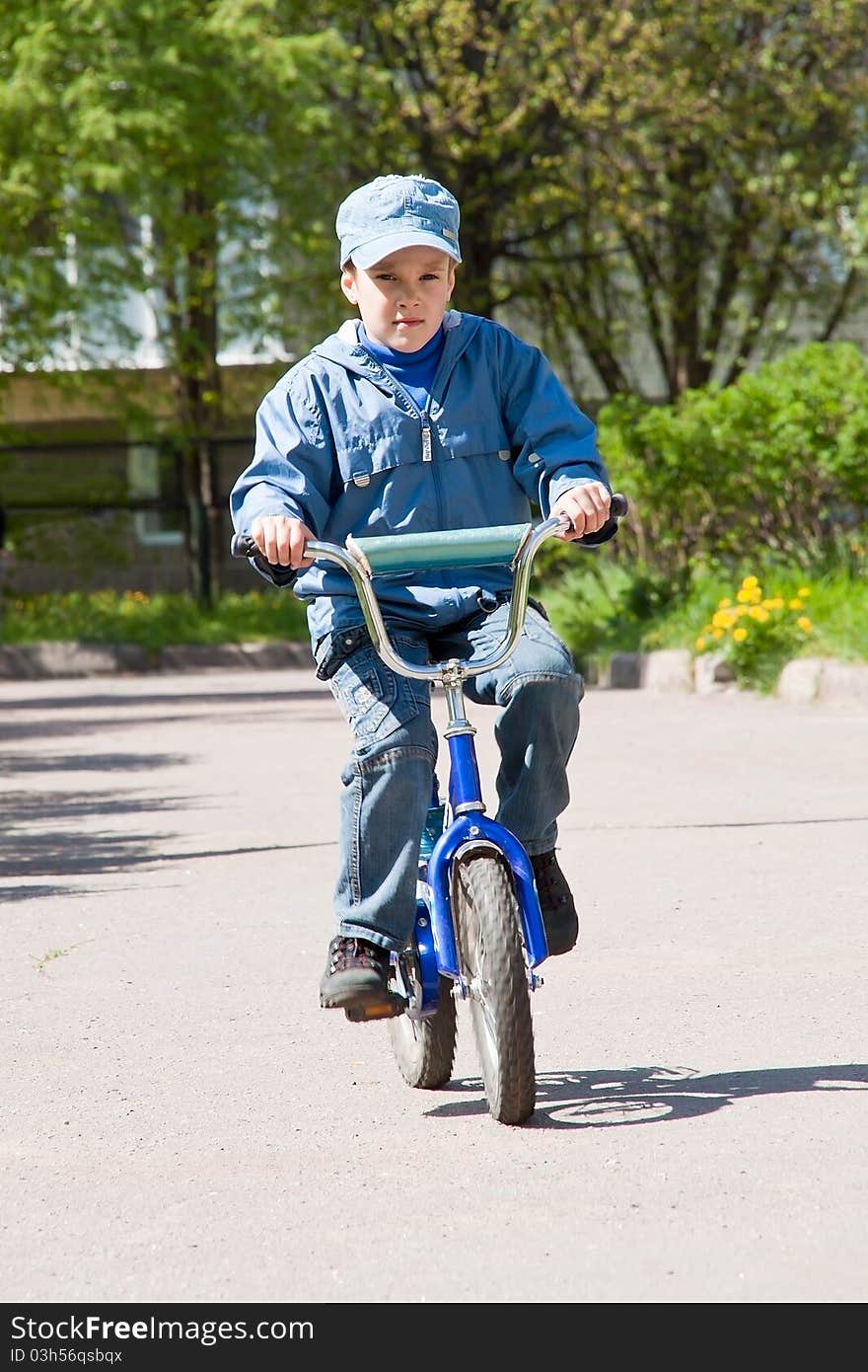 Boy riding his bicycle along the path. Boy riding his bicycle along the path