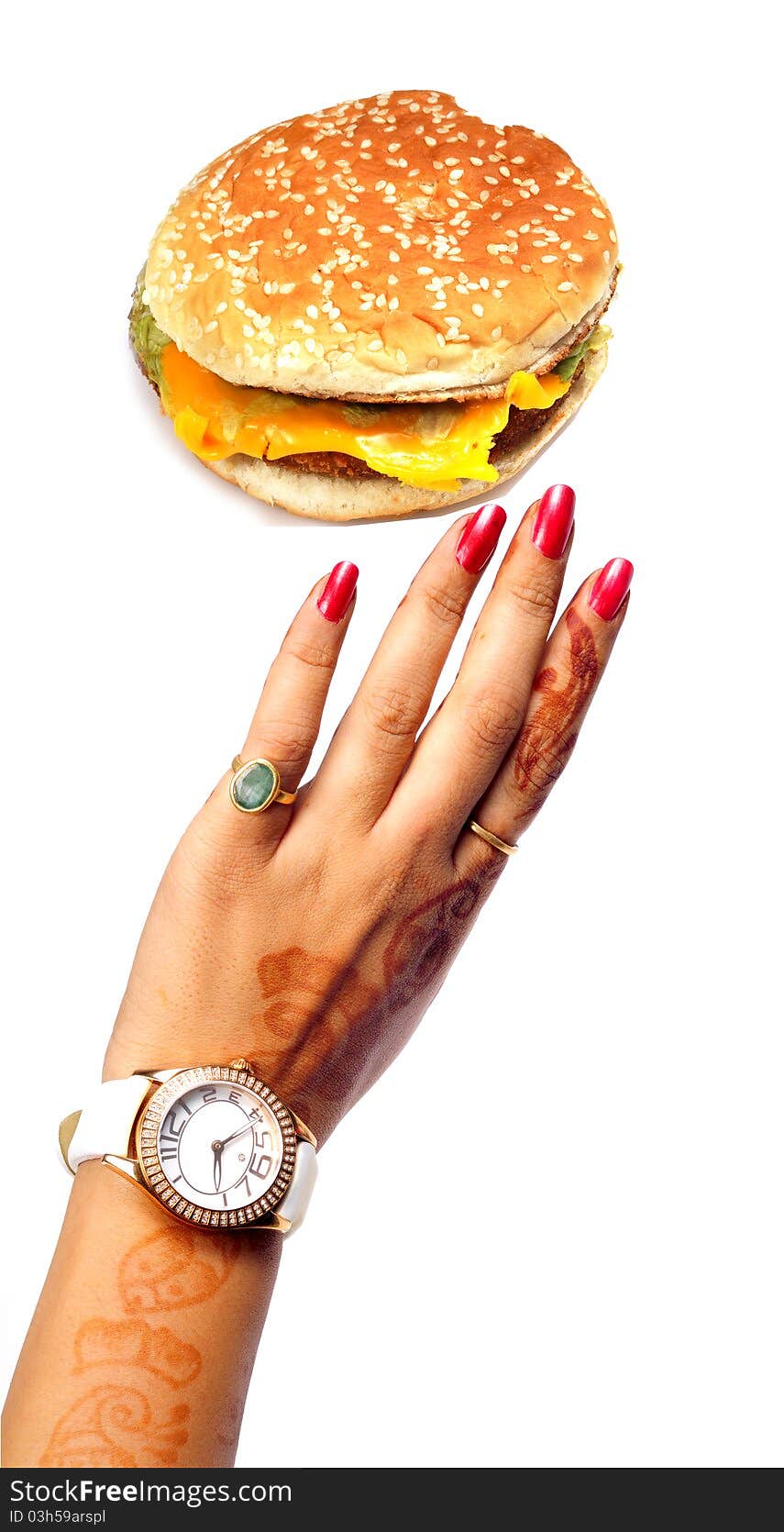 Female hand reaching cheese burger on white background. Female hand reaching cheese burger on white background.