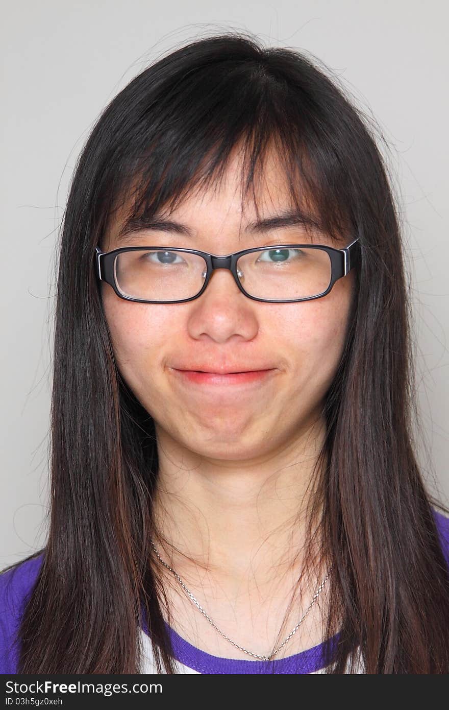 She is wearing glasses and typical asian. She is wearing glasses and typical asian.