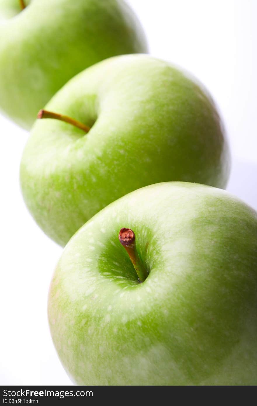 Three ripe green apples. On white background