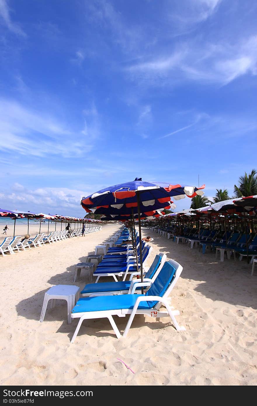 Group of canvas bed and beach umbrellas placing on the Cha-am beach of Thailand