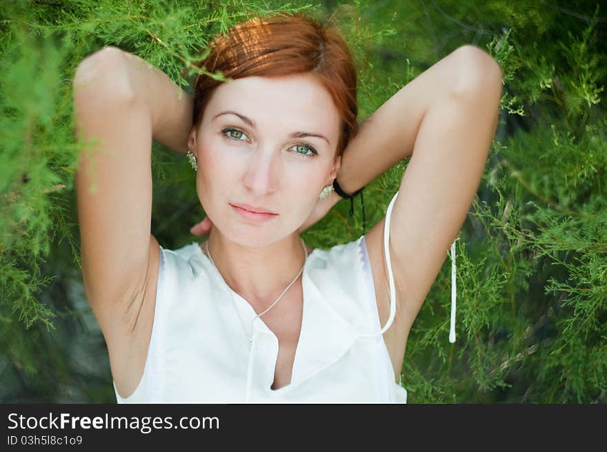 Looking beautiful young woman in a garden at sunny summer day. Looking beautiful young woman in a garden at sunny summer day