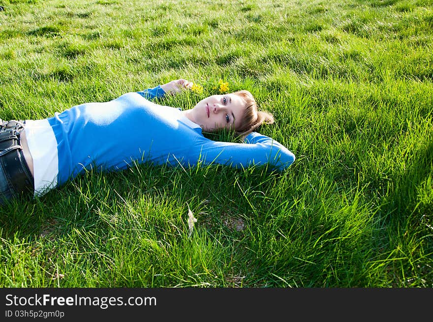 Beautiful girl lying on the green grass. Beautiful girl lying on the green grass