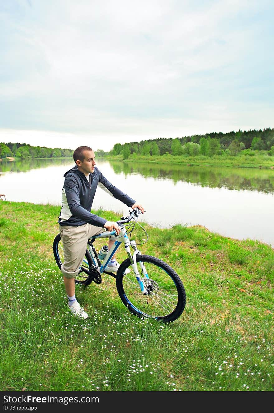 Young man on a bicycle in forest