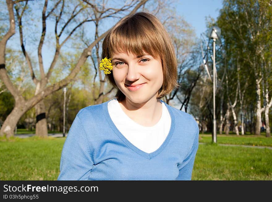 Smiling Girl Sitting In The Park