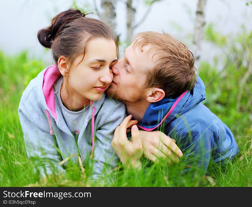 Portrait of a happy couple lying together on grass