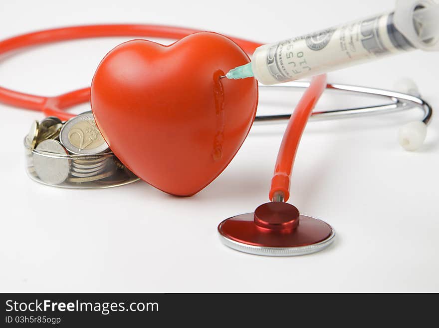 Healthcare cost money coins and bills with a red stethoscope and blood drop. Healthcare cost money coins and bills with a red stethoscope and blood drop