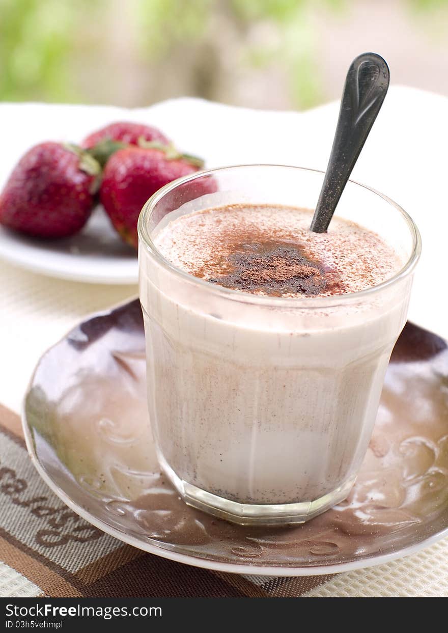 A glass of fresh coffee latte with cocoa