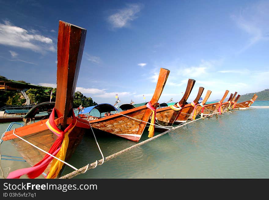 Long-tail boats parking in front of a resort on Lipe Island, Tarutao National Park Thailand. Long-tail boats parking in front of a resort on Lipe Island, Tarutao National Park Thailand