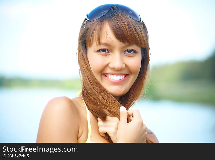 Portrait of young beautiful woman with fair hair on background of the lake. Portrait of young beautiful woman with fair hair on background of the lake