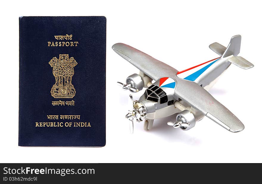 Indian passport with toy plane isolated on white background. Indian passport with toy plane isolated on white background.