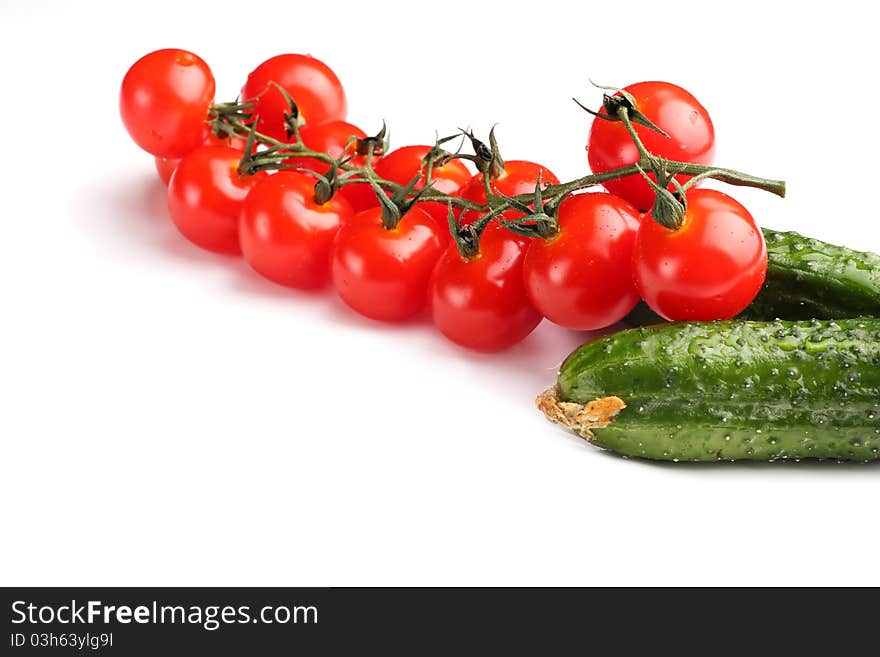 Cherry tomatoes and cucumbers on a white background. Cherry tomatoes and cucumbers on a white background