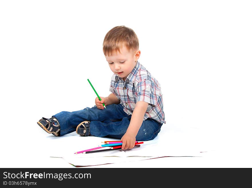 Two, three years old baby boy sitting with color pencil drawing isolated on a white background. Two, three years old baby boy sitting with color pencil drawing isolated on a white background