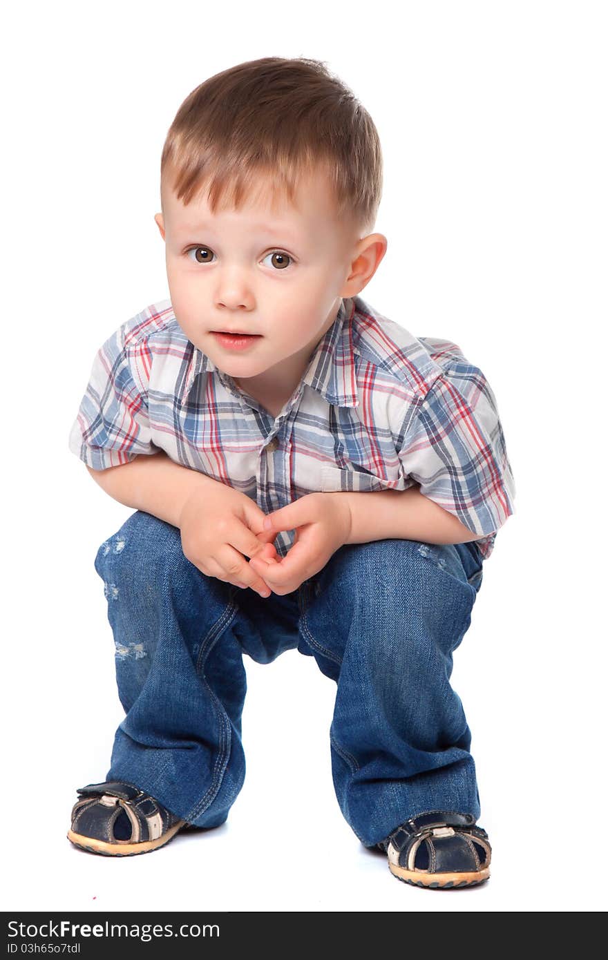 Cute little boy sitting isolated on white background. looking at camera. concept. Cute little boy sitting isolated on white background. looking at camera. concept.