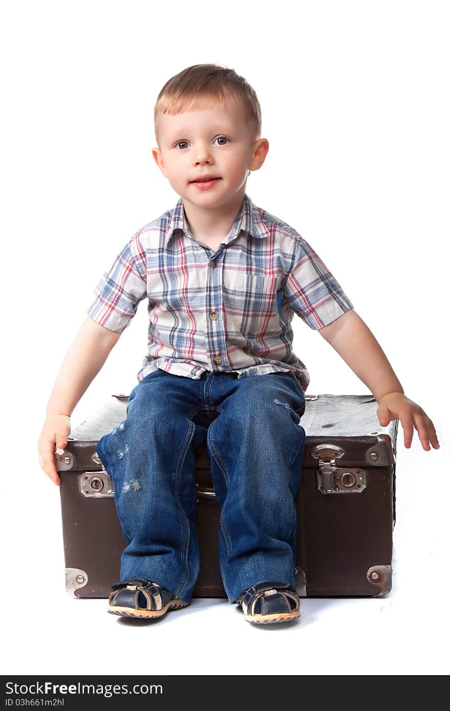 Two, three years old baby boy sitting on big suitcase isolated on a white background. transportation, moving, journey concept.