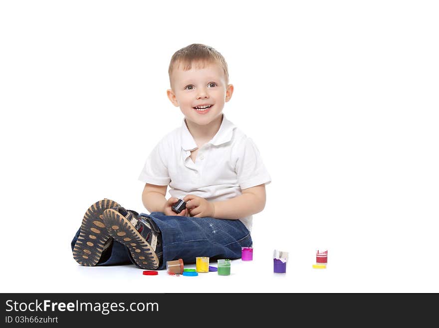 Two, three years old baby boy paints isolated on a white background