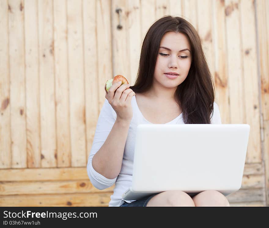 Girl sitting in the stairs with laptop