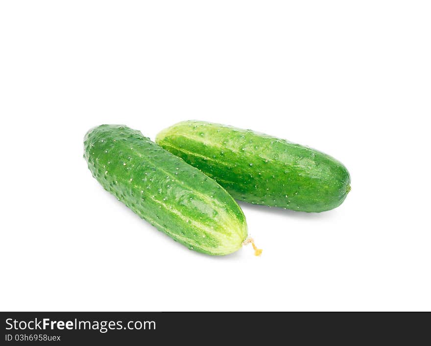 Green cucumbers on white background