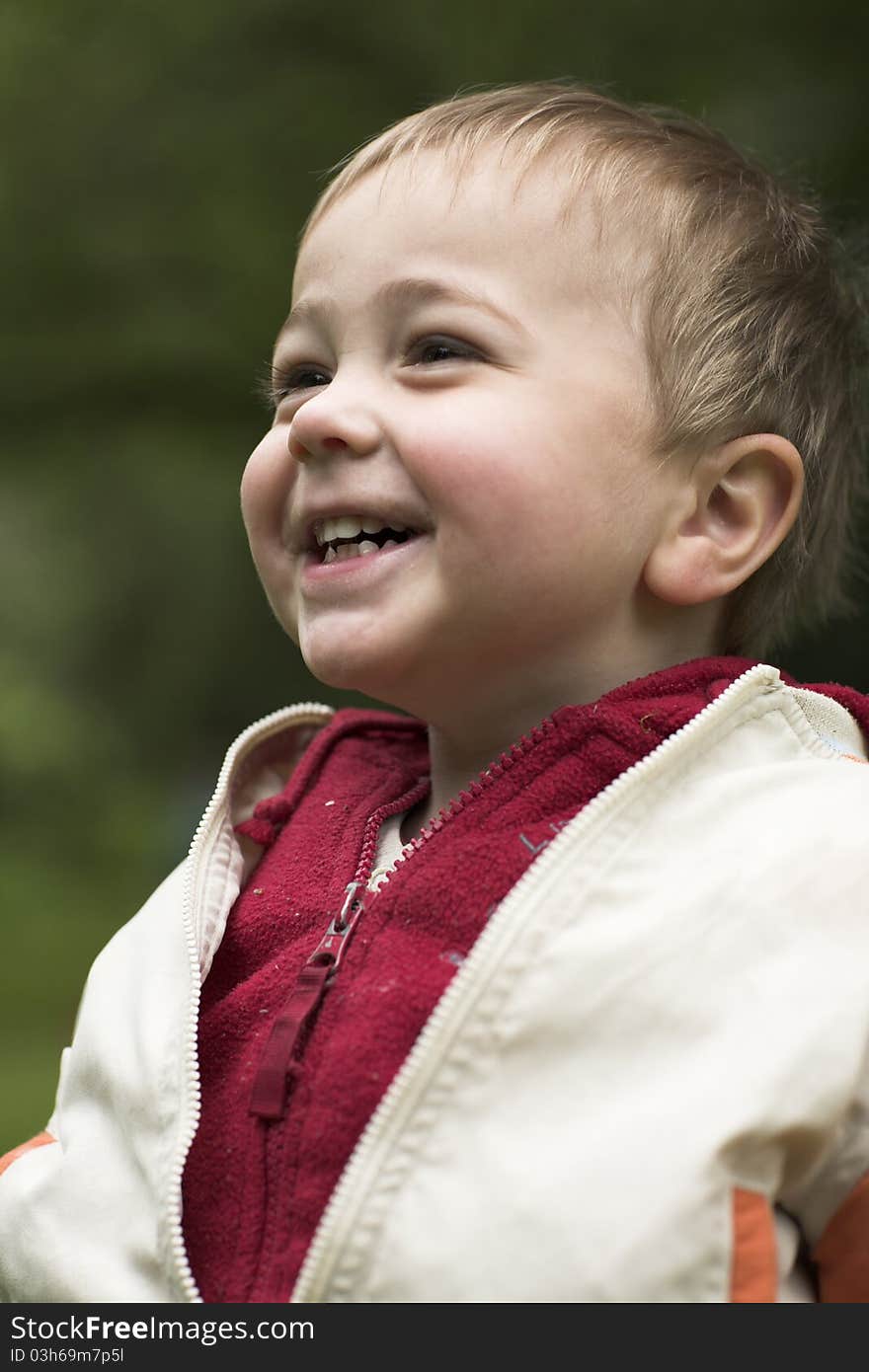 Little boy laughs in park