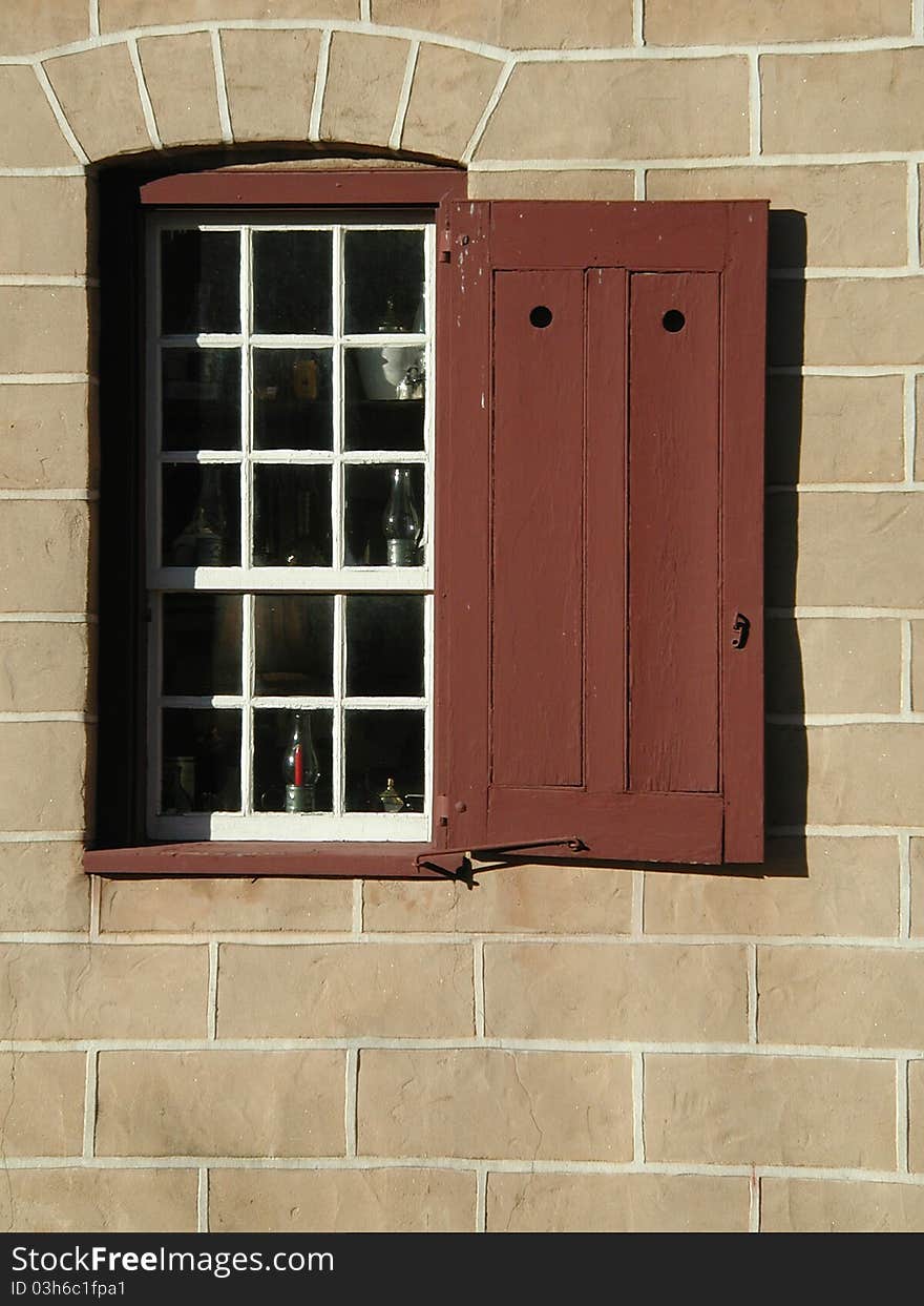 Detail of a window and shutter on a colonial-era building in NC. Detail of a window and shutter on a colonial-era building in NC