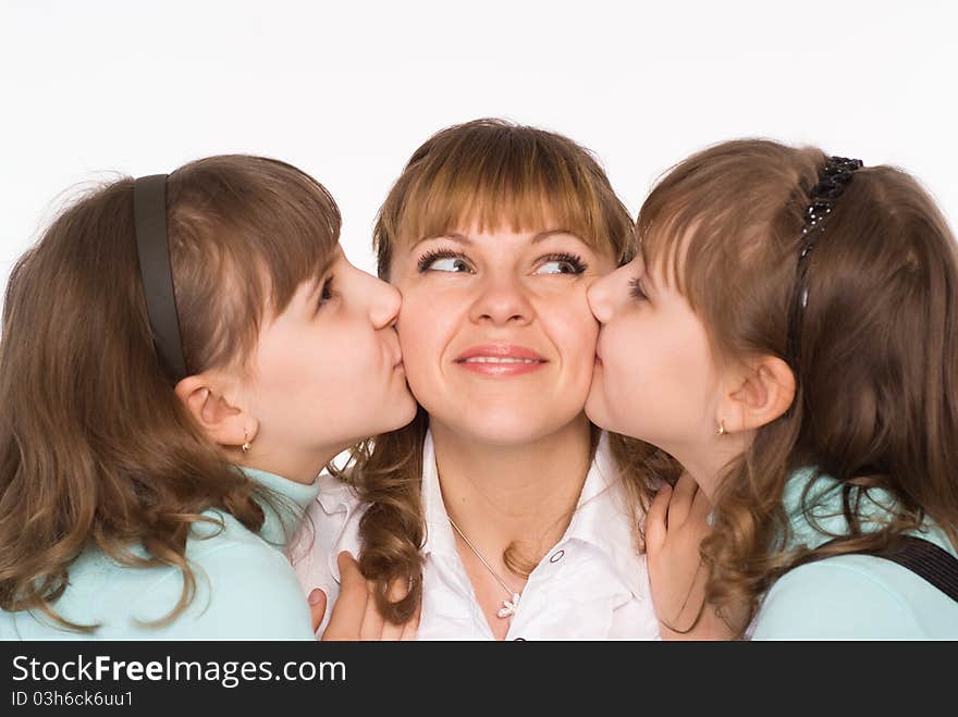 Beautiful mom and daughters on a white background. Beautiful mom and daughters on a white background