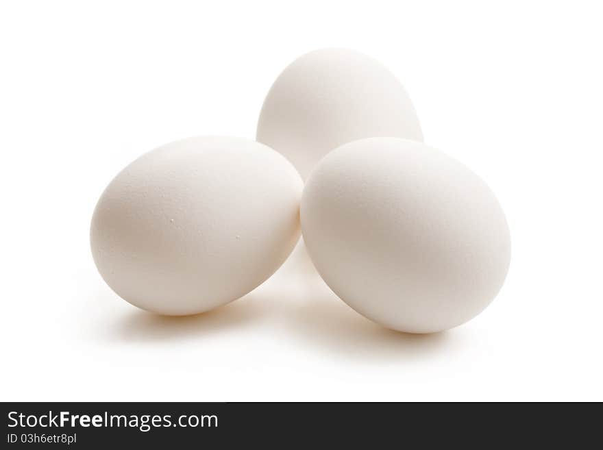 Three white eggs isolated on white.