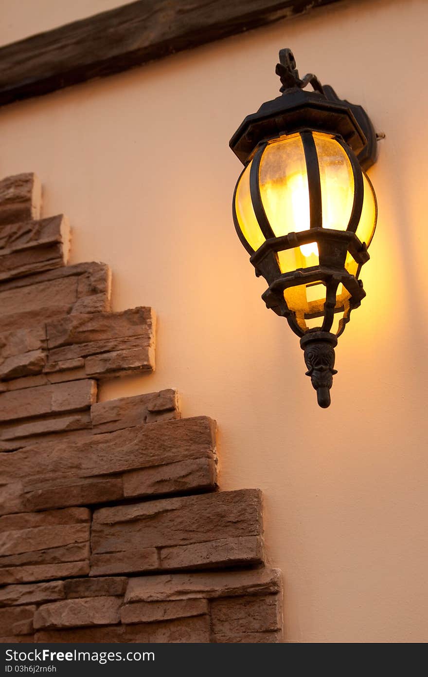 Ancient lantern on a wall in the evening