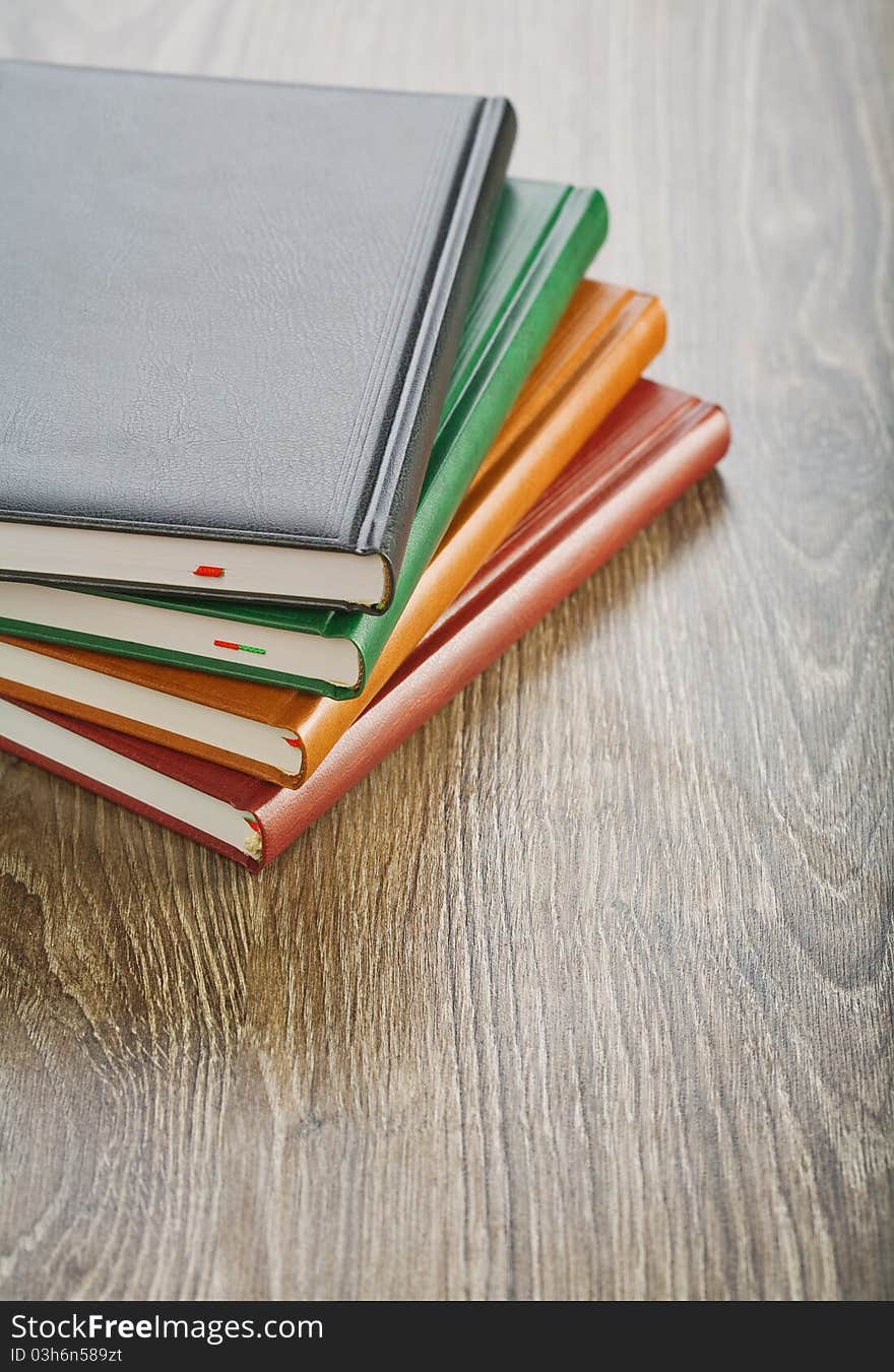 Notebooks on wooden board