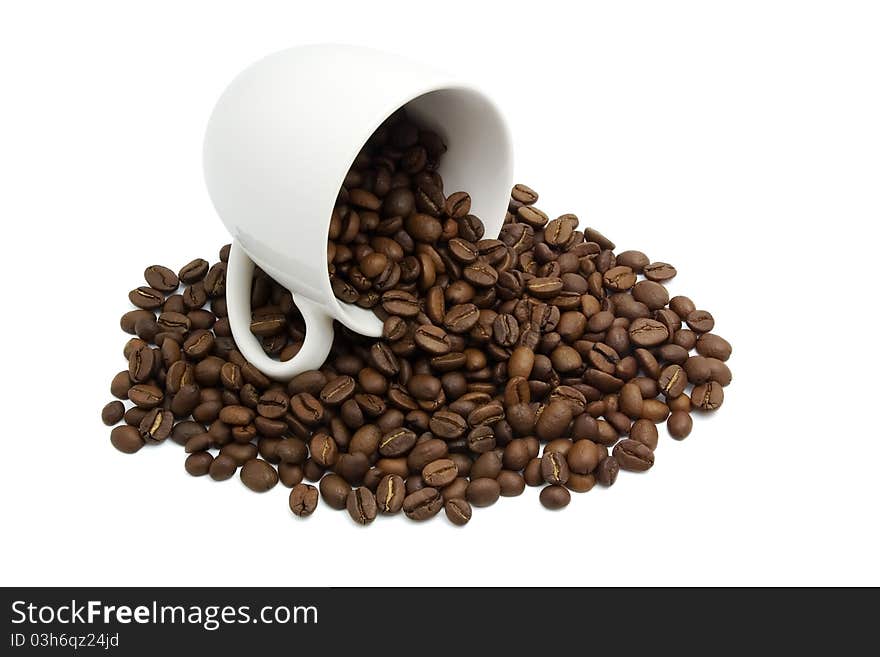 White cup with coffee beans isolated in white