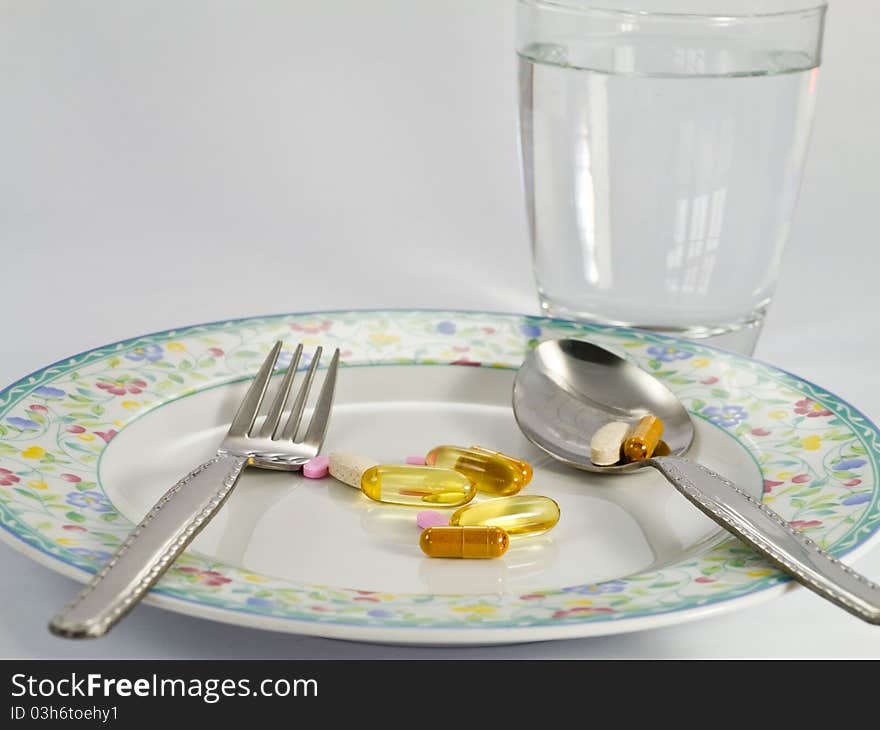 Various pills on dish, everyday meal time