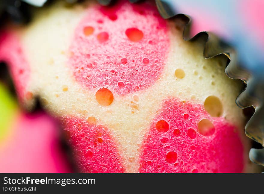 Close up view of the delicious colorful cup cakes showing craters. Close up view of the delicious colorful cup cakes showing craters